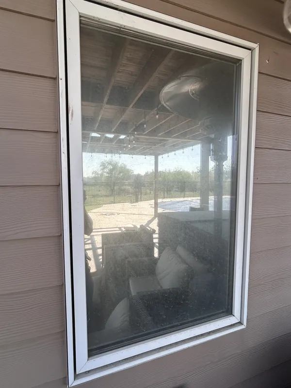 Before: Exterior window on a tan house